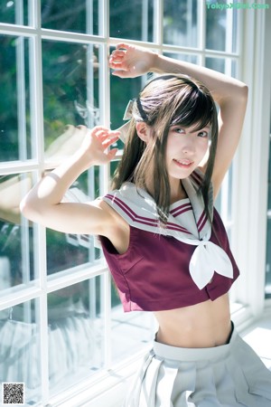 A woman in a school uniform is posing for a magazine.