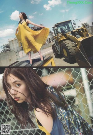 A woman in a yellow dress standing in a field.
