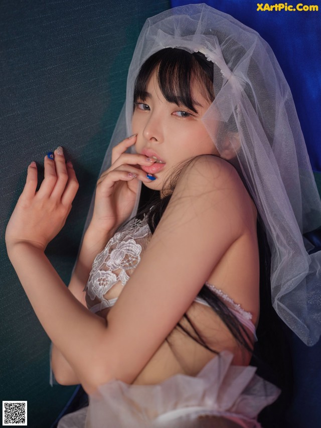 A woman in a wedding dress with a veil over her head.