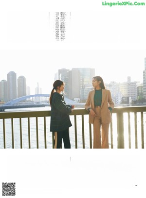 Two young women standing on the steps of a building.