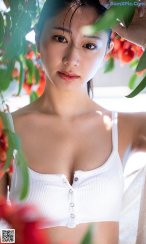 A woman in a white bra posing for a picture.