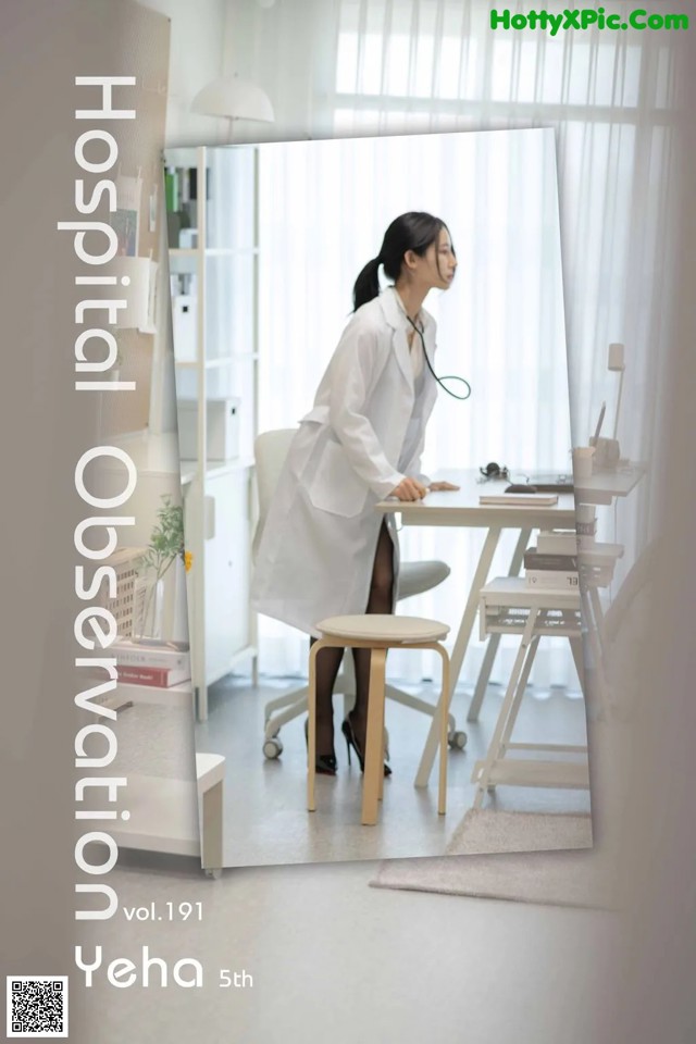 A woman in a white lab coat sitting at a desk.