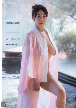 a japanese woman with big tits is sitting in a bathtub